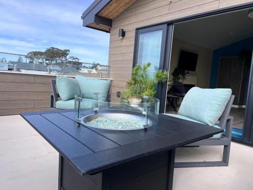 a table with a glass bowl on a patio at HarborWalk Inn in Morro Bay