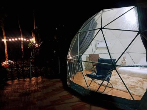 a glass dome with a chair inside of it at เกรทแลนด์เขาใหญรีสอร์ท in Ban Tha Chang