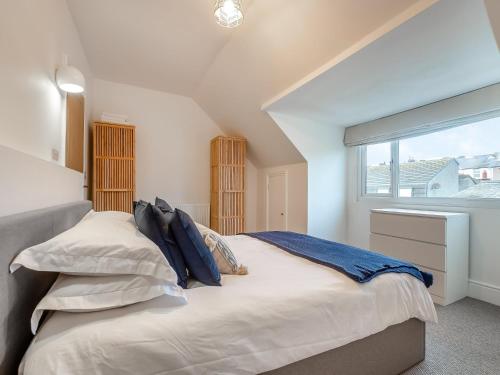 a bedroom with a large bed and a window at Townhouse in Llandudno