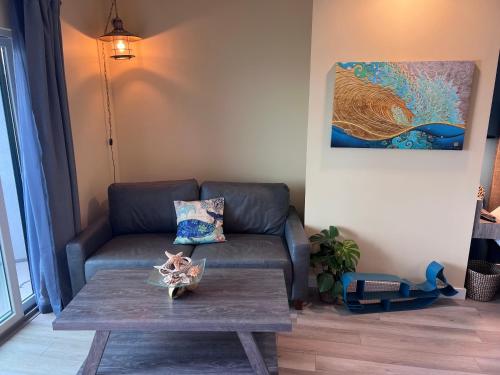 a living room with a couch and a coffee table at HarborWalk Inn in Morro Bay