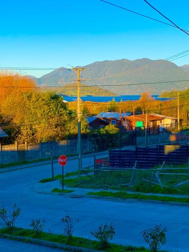 a stop sign on a street with mountains in the background at Casa mirador lago in Panguipulli