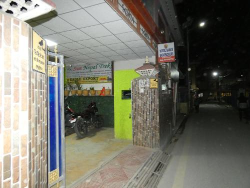 a garage with a motorcycle parked inside of it at Sara's Backpackers Hotel in Kathmandu