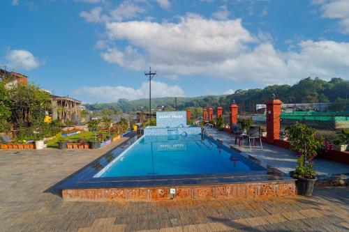a large swimming pool on top of a building at Berry Fresh Stays Mahabaleshwar With Pool in Mahabaleshwar