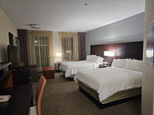 a hotel room with two beds and a television at Five minutes walk unit Disneyland Anaheim Staybridge Suites in Anaheim
