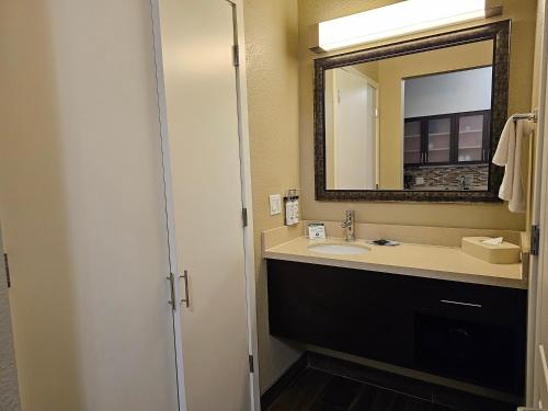 a bathroom with a sink and a mirror at Five minutes walk unit Disneyland Anaheim Staybridge Suites in Anaheim
