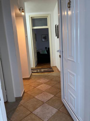 a hallway with a door and a tile floor at City Apartment Gevgelija in Gevgelija