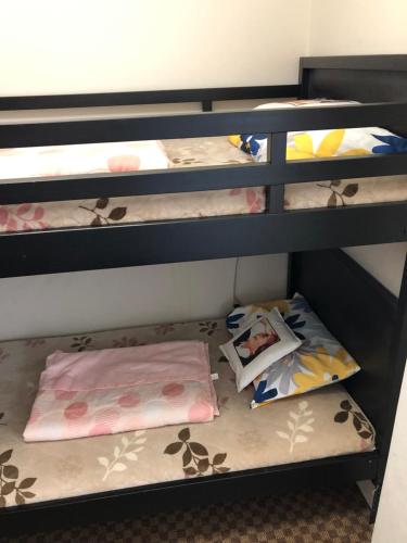 four bunk beds in a room with their mattresses at Hanmadang in Osaka