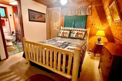 a bedroom with a wooden bed in a cabin at Mountain Springs Chalet in Gatlinburg