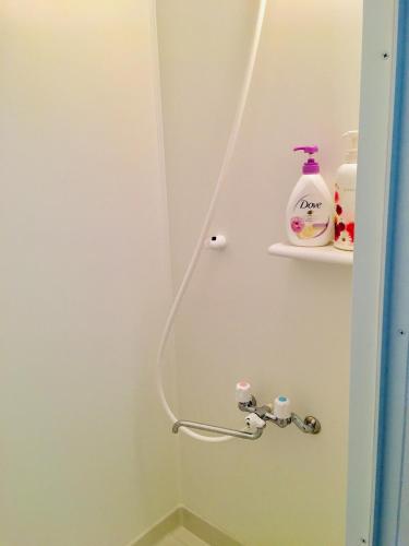 a bathroom with a toilet and a shelf with soap at Hanmadang in Osaka