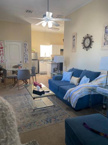 a living room with a blue couch and a table at Southern’s Beauty 1 Very close to Airport in Kenner