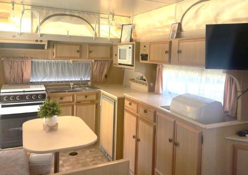 a kitchen with a small table in a rv at Kerang Holiday park in Kerang