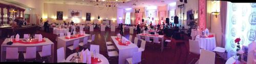 a room with white tables and chairs in a room at Victoria Hotel in Minden