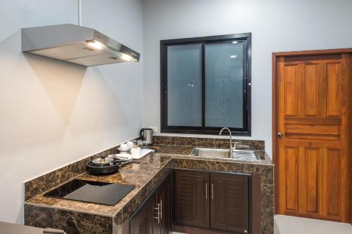 a kitchen with a sink and a counter top at Mook Anda Villa in Ao Nang Beach