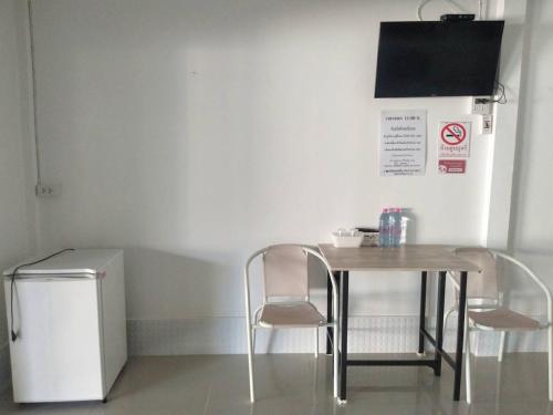 a table and two chairs in a room at Saan Rak Resort in Prachuap Khiri Khan