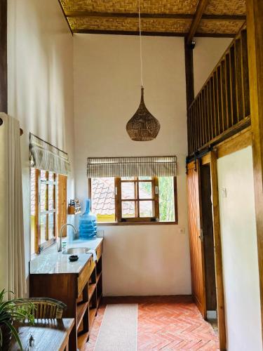 a kitchen with a sink and a window at Santai House in Tetebatu