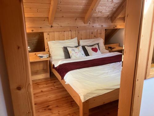 a bedroom with a bed in a wooden cabin at Ferienwohnungen Hannesbichler in Patergassen