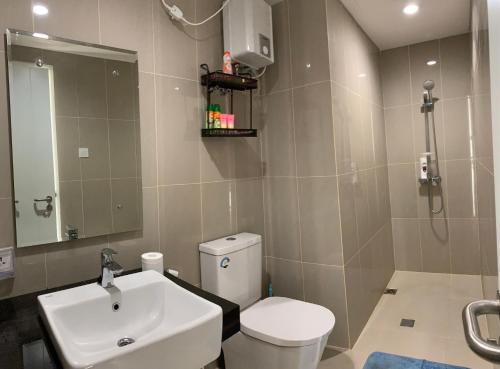 a bathroom with a white toilet and a sink at Two Bedroom Apartment at The Nove Nuvasa Bay Nongsa 306 in Nongsa