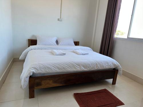 a bedroom with a bed with two towels on it at narixay hotel in Phonsavan