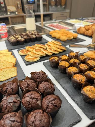 a bunch of different types of muffins and other desserts at Hotel Romantic in Cavaion Veronese