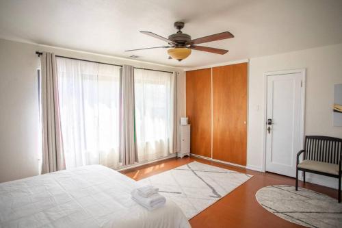 a bedroom with a bed and a ceiling fan at PlanetView Delux Richmond XL- walk Best MexFood in Richmond