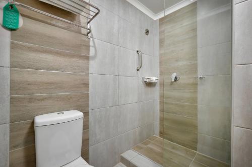 a bathroom with a toilet and a shower at Protea Hotel by Marriott Klerksdorp in Klerksdorp