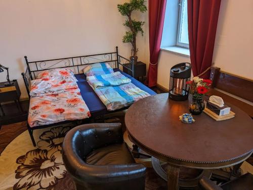 a small bedroom with a bed and a table and a tableablish at naturnah am Donauradweg in Riedlingen