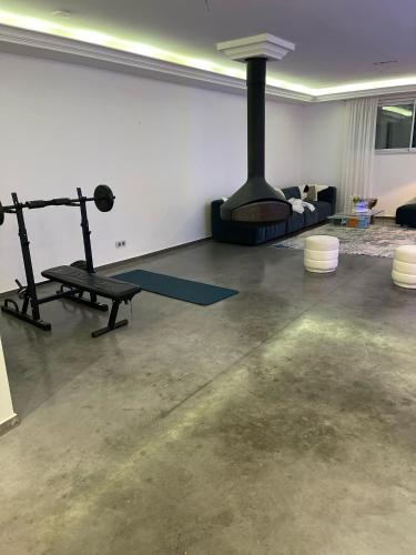 a living room with a gym with a fireplace at JD HOME in Beauvais