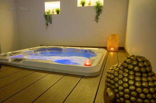 a jacuzzi tub sitting on a wooden floor at Logis HOTEL DU PARC in Pont-à-Mousson