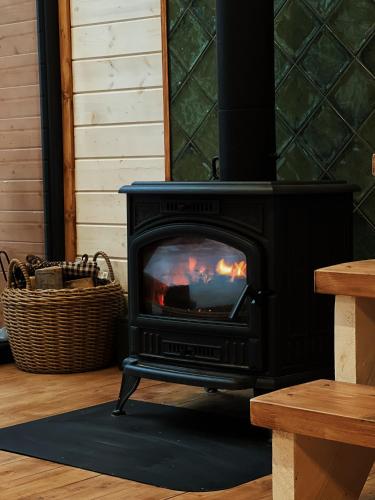 a black stove with a fire in a room at Chili Shale in Yablunytsya