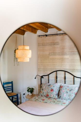 a mirror reflecting a bed in a bedroom at Perivolakia Panorama House in Perivolákia