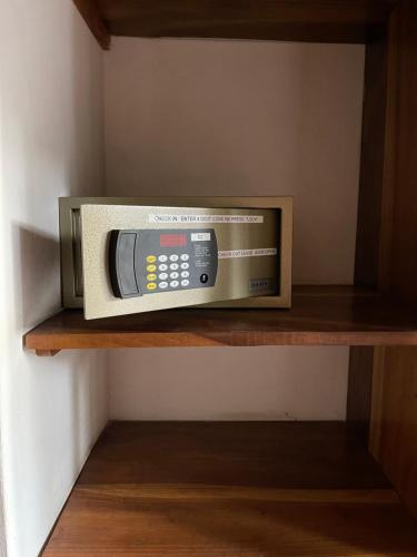 a microwave oven sitting on a shelf in a room at Villa Wonne 1 Floor Family Appartement! in Arugam Bay