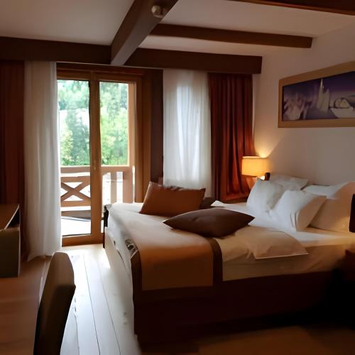a hotel room with two beds and a window at Apartments B229 & B230 in Aparthotel Vucko, Jahorina -private host in Jahorina