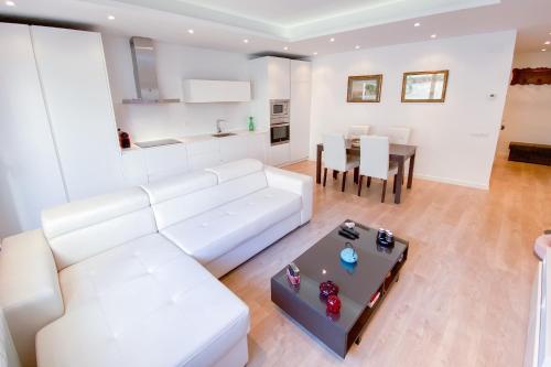 a living room with a white couch and a table at Anna & Thomas - Sitges Center Apt in Sitges