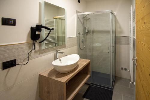 a bathroom with a sink and a shower at La Lesivèra Bed and Breakfast in Tione di Trento
