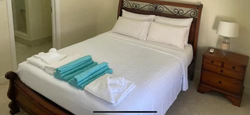 a bedroom with a bed with towels on it at Westland villa's in Saint James
