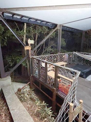a building with a cage with a bed in it at Sound Villa in Kannami