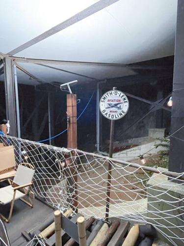 a building with a fence and a sign on it at Sound Villa in Kannami