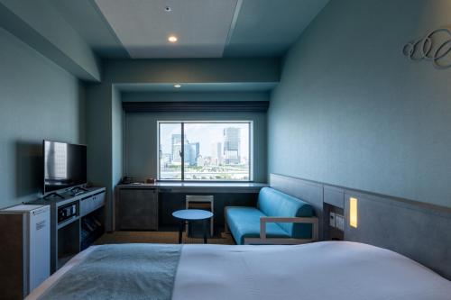 a hotel room with a bed and a window at La Vista Tokyo Bay in Tokyo