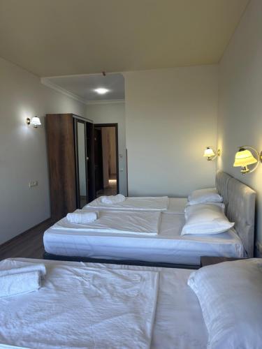 a group of four beds in a room at Majestic in K'obulet'i