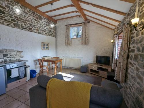 a living room with a couch and a table at Immaculate 1-Bed Cottage in Bideford in Bideford