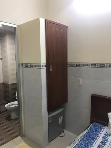 a bathroom with a toilet and a cabinet on the wall at Motel Liên Anh in Vung Tau