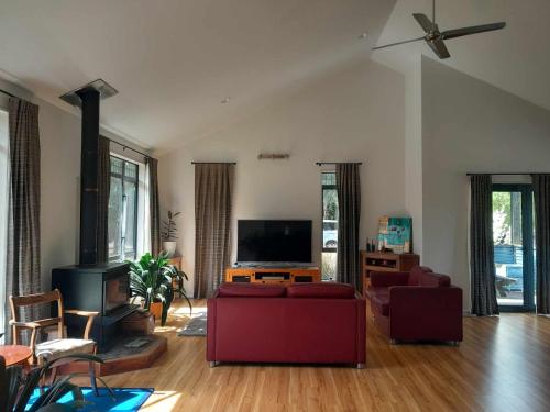 a living room with a couch and a flat screen tv at Springfield Retreat 4 bedrooms in Springfield