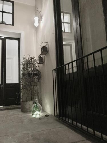 a vase sitting on the floor in front of a door at B&B Antica Dimora dell'Angelo in Nardò