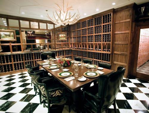 a dining room with a table and chairs and a chandelier at Los Angeles Athletic Club in Los Angeles