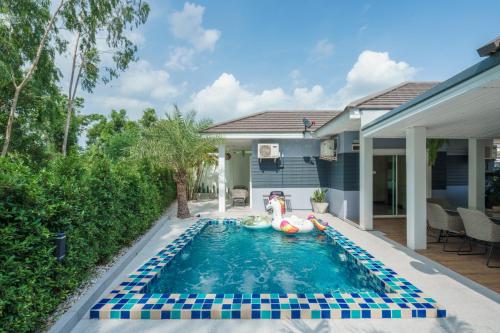 a pool with a raft in the middle of a house at Ioon Resort ไออุ่นรีสอร์ท in Sara Buri