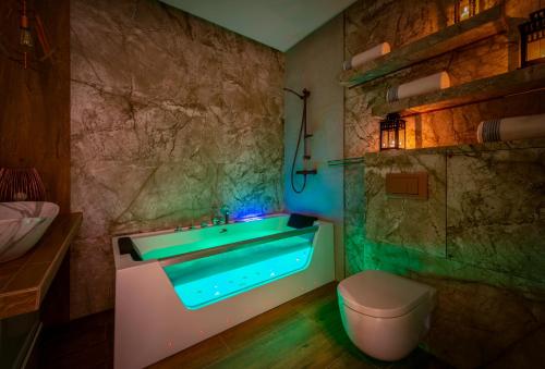 a bathroom with a bath tub and a toilet at Premium Apartment for Old Town & Jewish Quarter - Balcony, Jacuzzi and Pool in Krakow