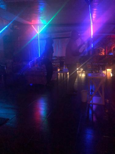 a group of people in a dark room with lights at SherNette Nest. in San Juan