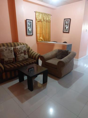 a living room with a couch and a coffee table at SherNette Nest. in San Juan