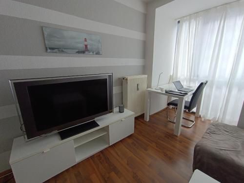 a living room with a large flat screen tv at Huge Private Room in Best Location in Düsseldorf