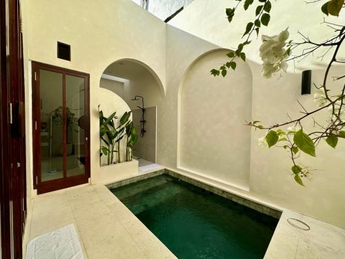 a swimming pool in the middle of a house at Trendy 1-Bedroom-Villa 'Lala' in Uluwatu in Jimbaran